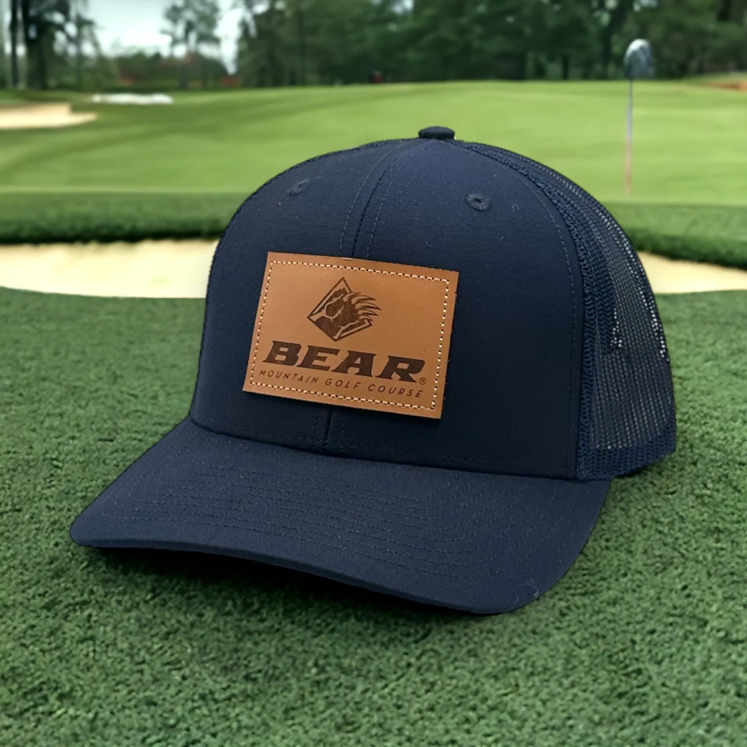 Blue trucker had with bear mountain logo on a leather patch on the front